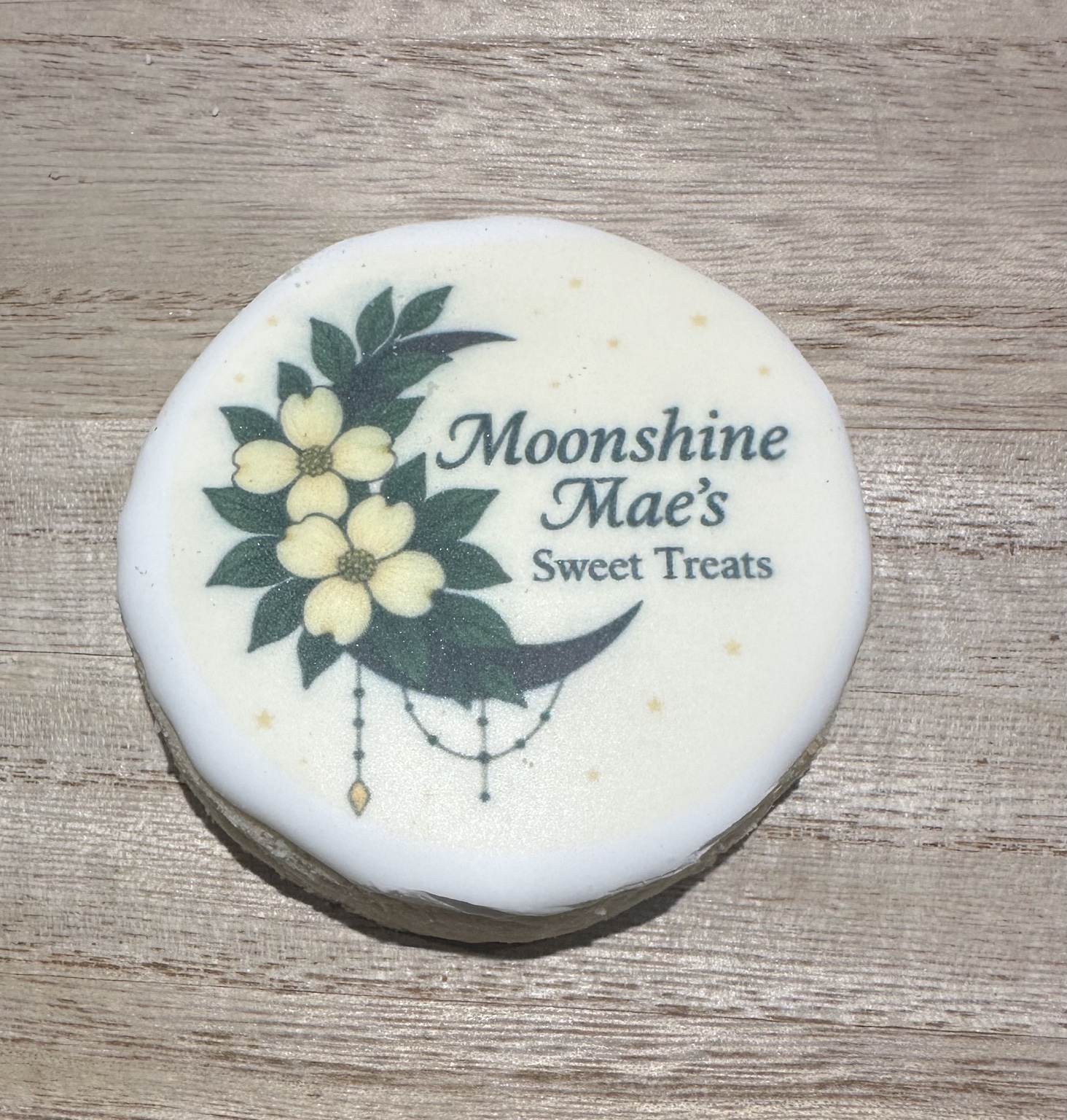 Moonshine Mae’s logo printed on a round cookie